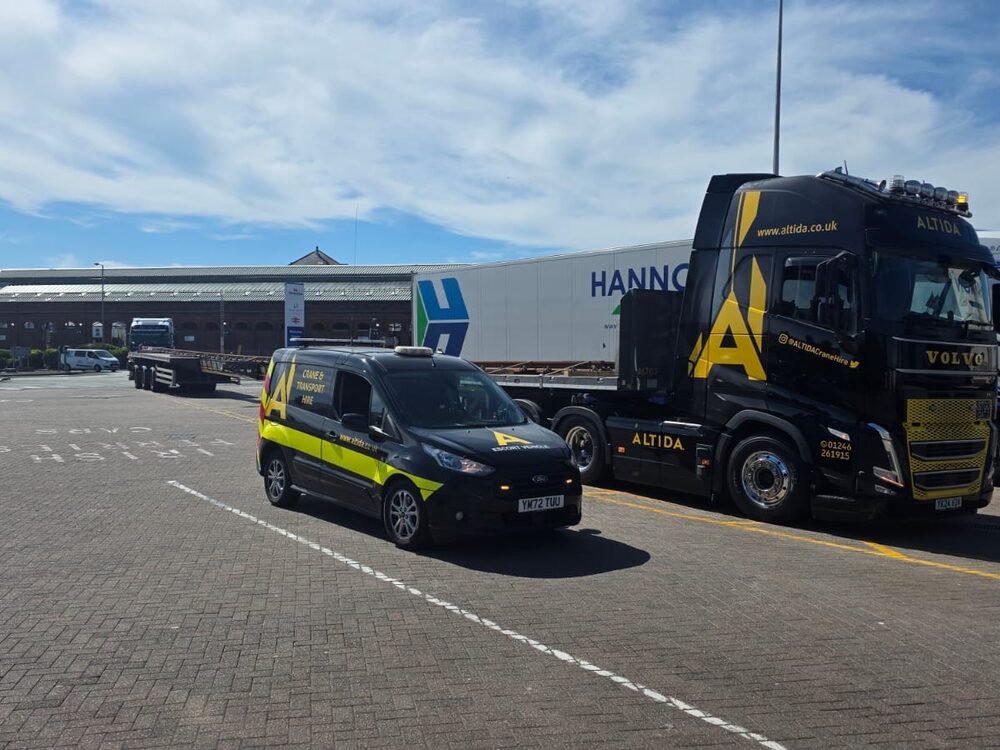 Altida's Volvo truck and in-house escort vehicle at a port on a 38.5-metre abnormal-load rail move to Ireland