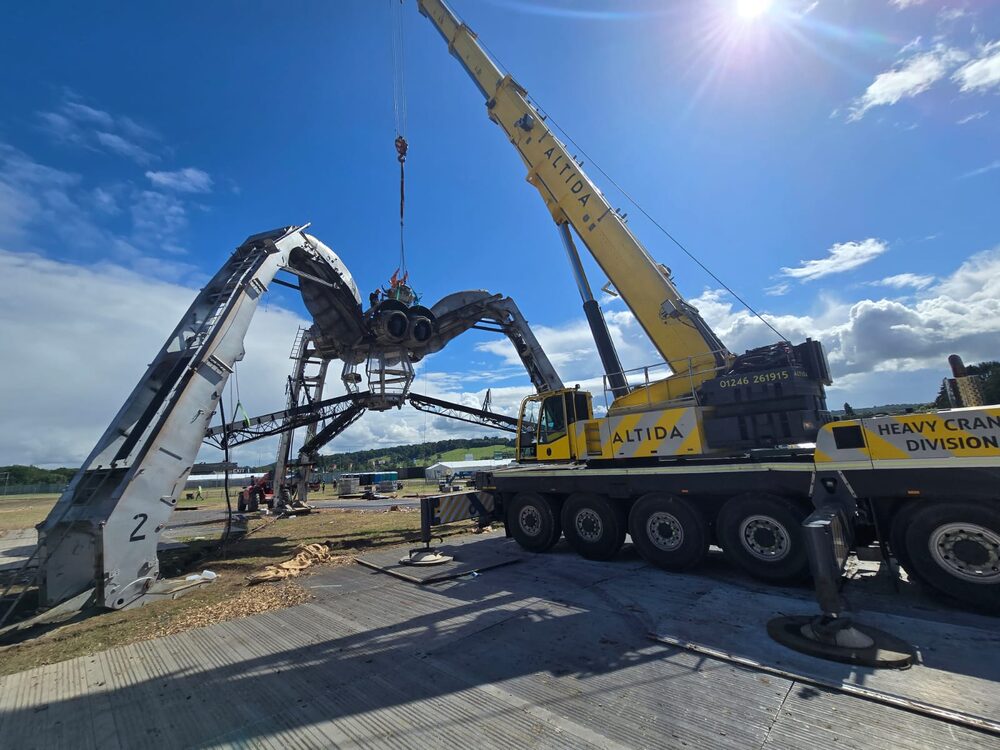 A 140-tonne all-terrain crane dismantling a towering steel art installation at a festival