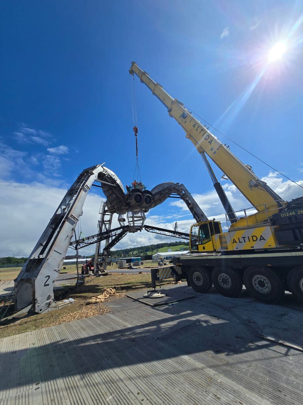 Altida's AC 140 dismantling a steel art installation at Forbidden Forest Festival — photo 6 of 7
